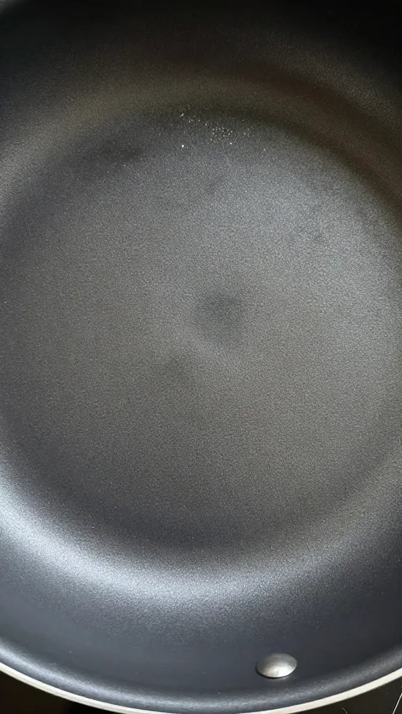 How to Clean Pots and Pans to Look Like New: Easy Fixes 3 closeup nonstick pan surface after scrubbing