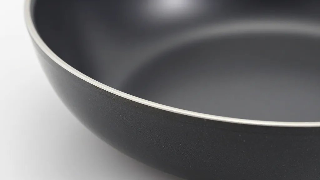 How to Fix Scratched Non Stick Pan in 5 Simple Steps 5 Focused shot of repaired nonstick pan edge with mild residue wipe-tsa