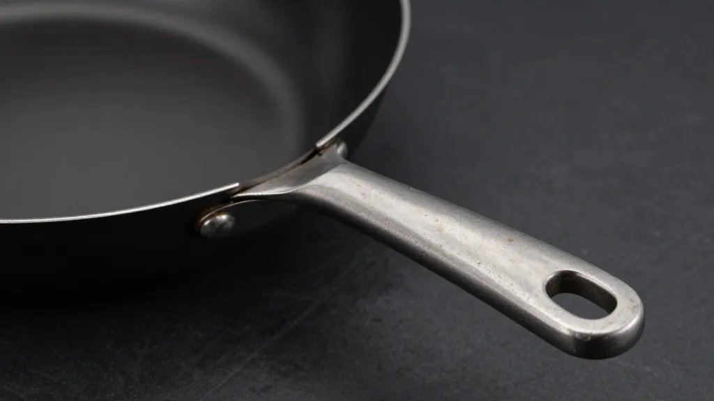 All Clad Vs Viking: Clash of Cookware Titans 3 Closeup of Viking chef-grade pan handle with forged steel texture