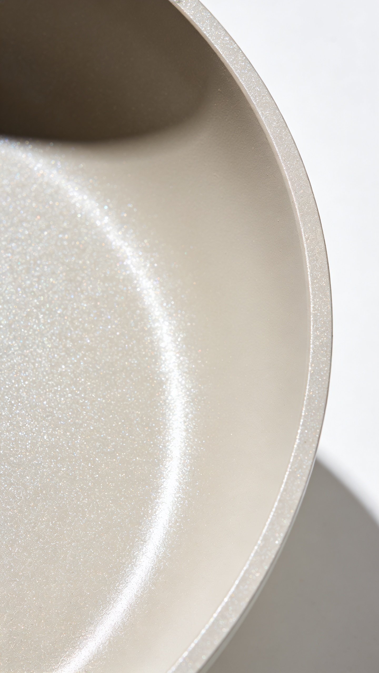 Are Non-Stick Pans Safe: What You Need to Know 2 Closeup of PTFE non-stick pan coating texture under bright studio light