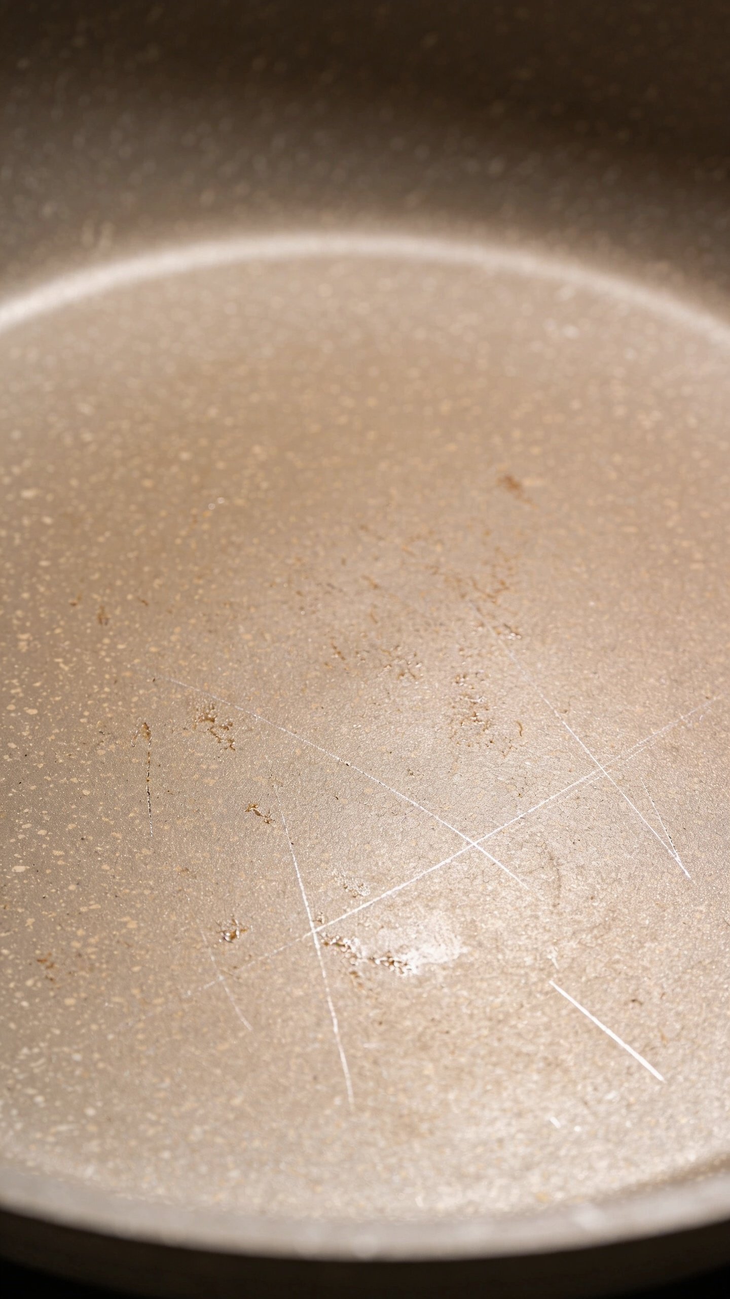 Are Non-Stick Pans Safe: What You Need to Know 3 Macro shot of ceramic non-stick pan surface with subtle wear marks