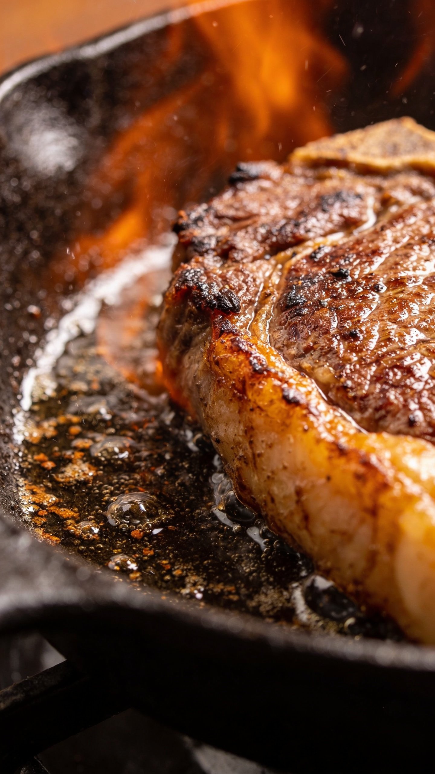 Cast Iron Vs Stainless Steel: Which Wins Your Kitchen? 4 Closeup: sizzling cast iron crust on steak edge contact with pan