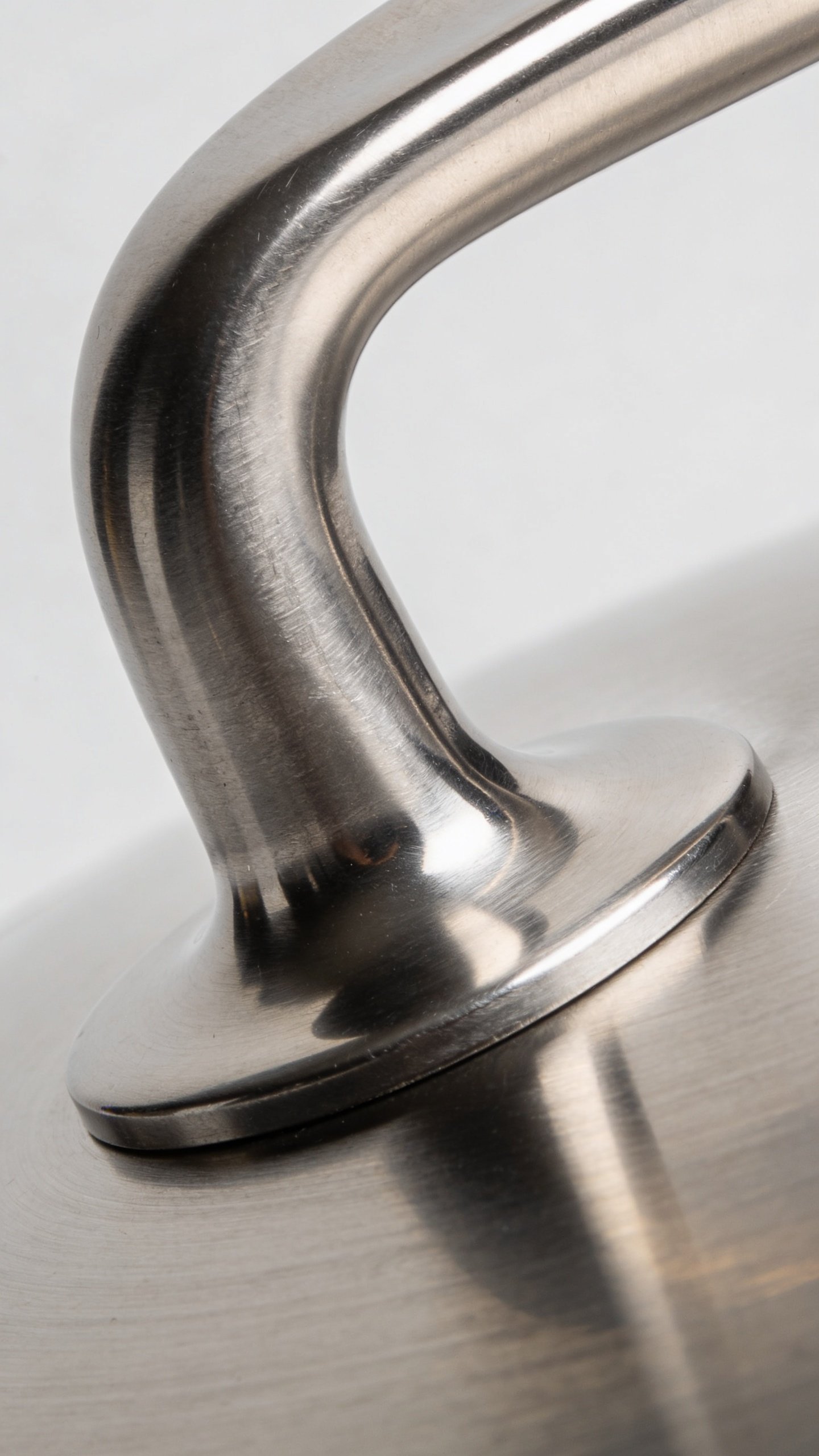 All Clad Vs Calphalon: Sizzle or Simplicity? 4 single All-Clad bonded pan handle hub, macro shot, stainless sheen, subtle grain