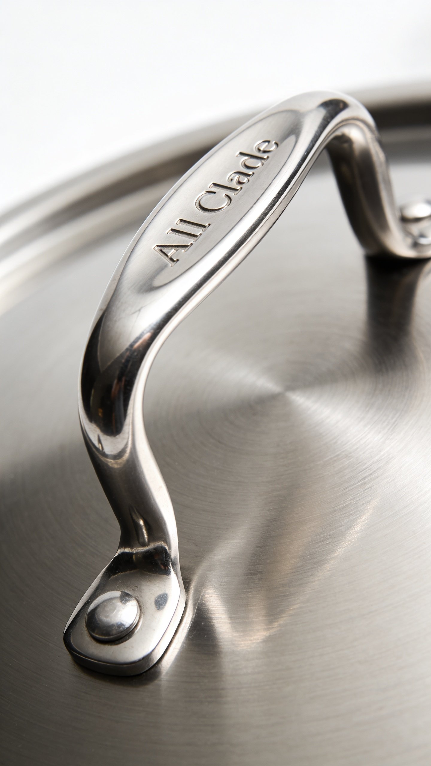 All Clad D3 Vs D5: Which Pan Wins for Your Kitchen 4 Macro shot of a single All-Clad pan handle with polished-silver finish on white backdrop