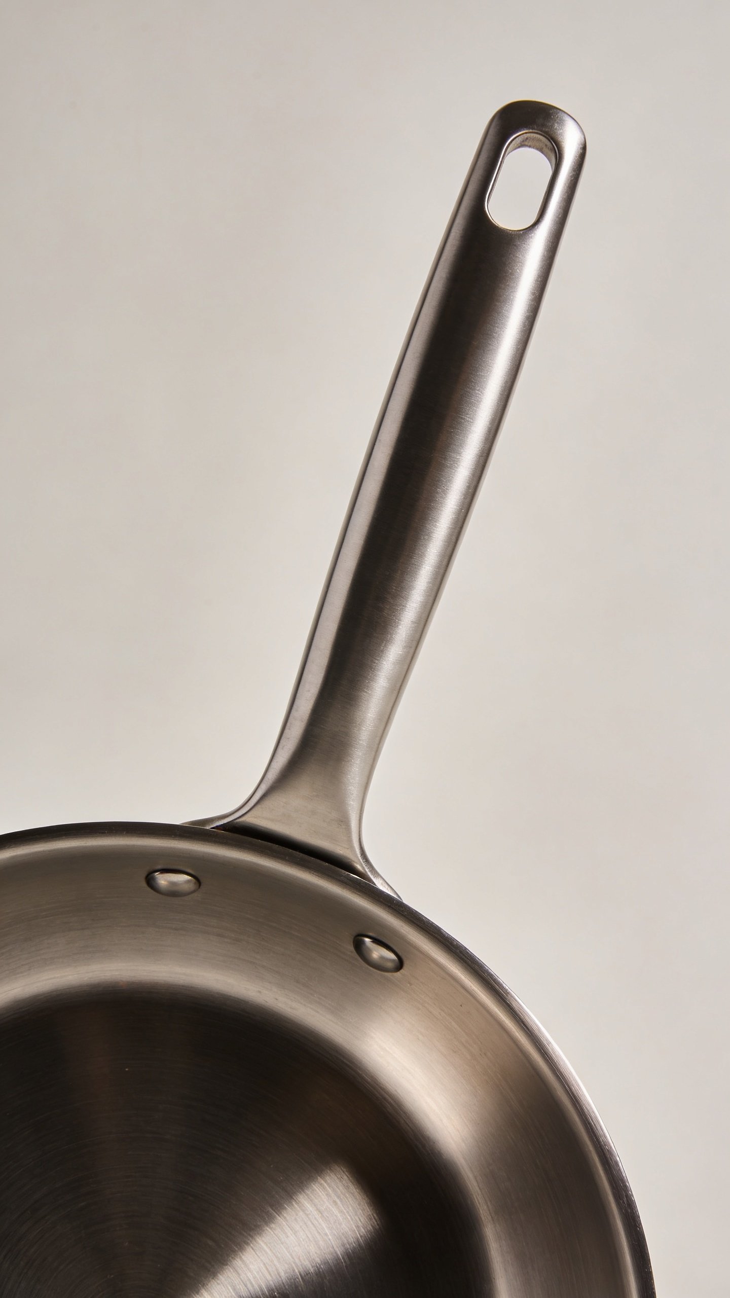 What Pans Do Chefs Use: the Kitchen’S Secret Tools 2 closeup of stainless steel chef's pan handle grip